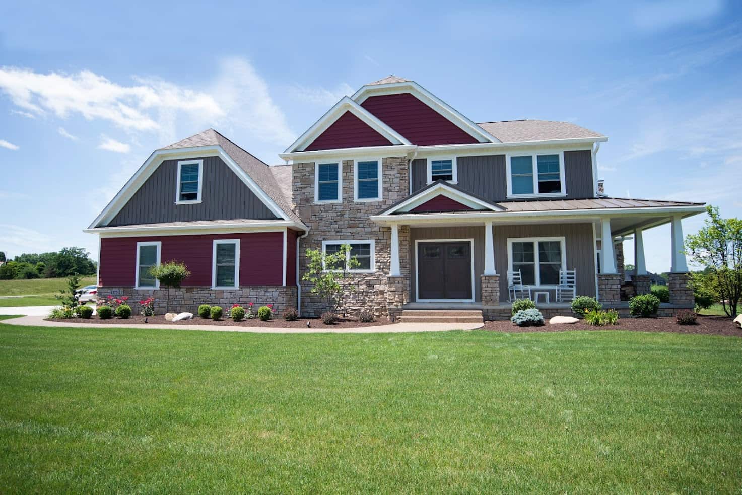 dark gray and maroon vinyl siding with some brick; siding installation by Lori K Home